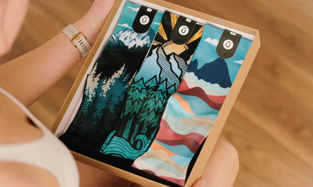 Person holding an OUTWAY sock 3-pack gift box