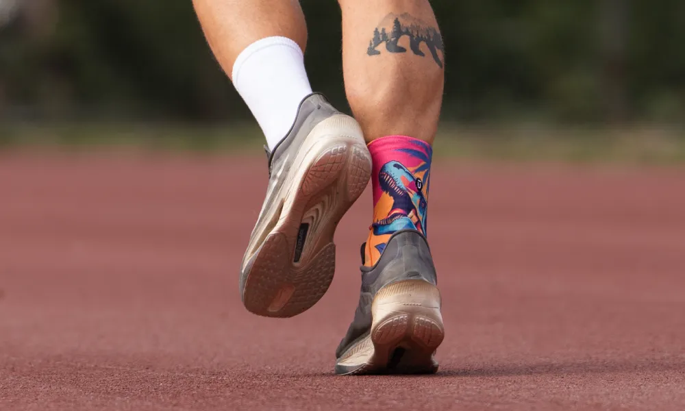 Runner on a track wearing OUTWAY athletic quarter socks