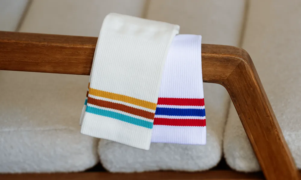 Two pairs of OUTWAY athletic crew socks with colourful stripes