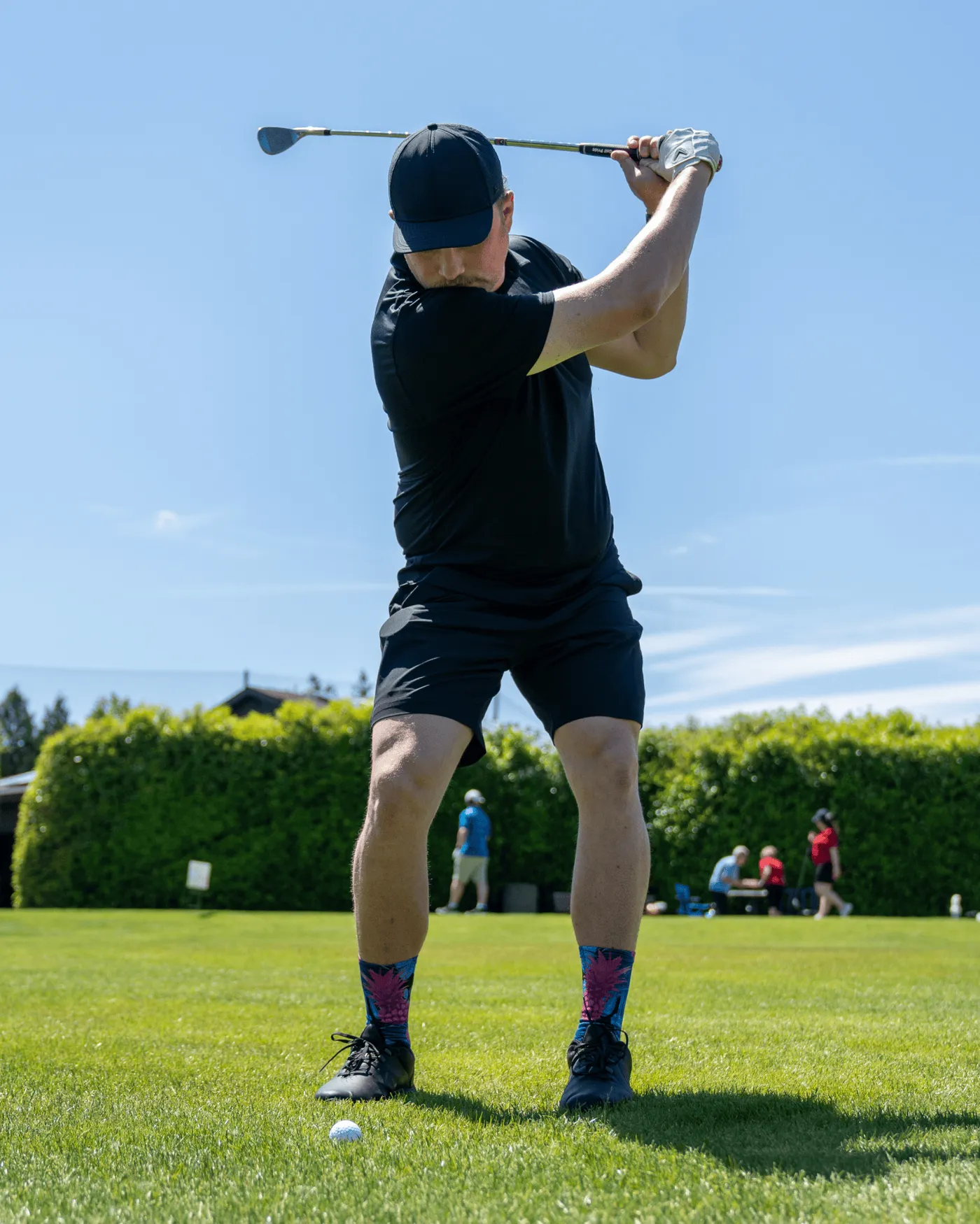 Golfer mid-swing in Outway socks
