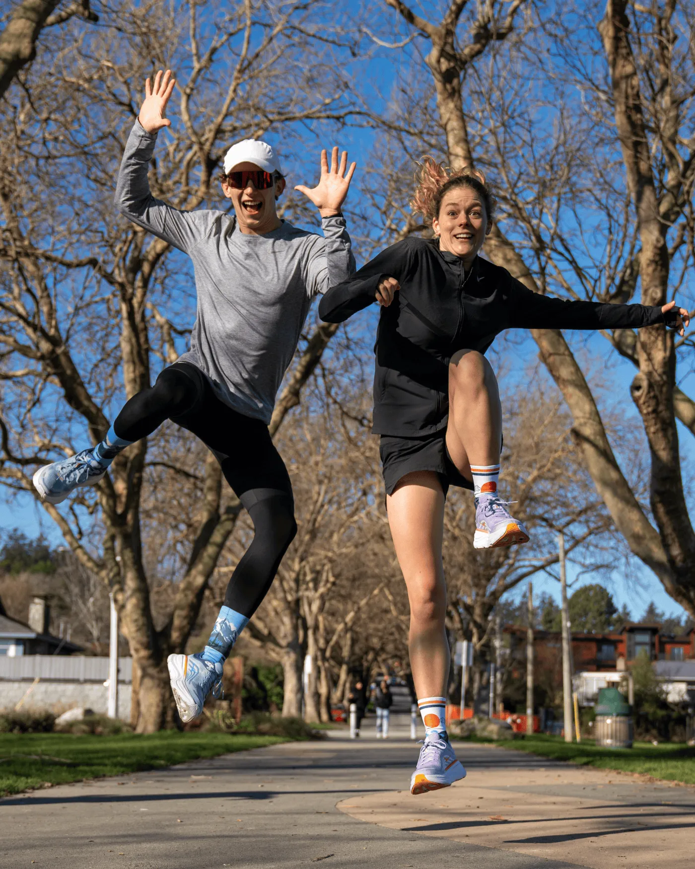 Two friends jumping outdoors in Outway socks